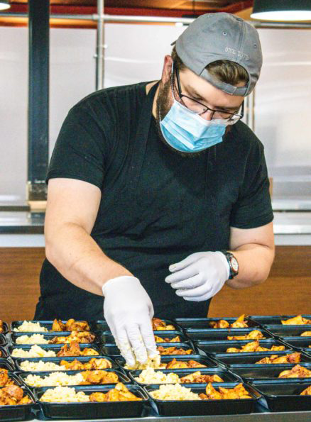 image of MyFitFoods employee assembling meals