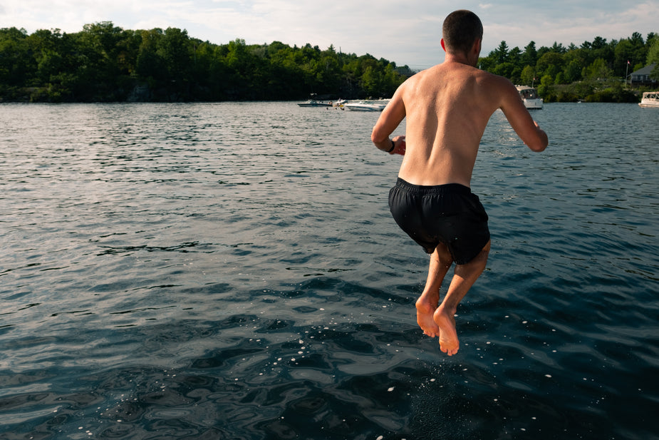 Image of person jumping into lake